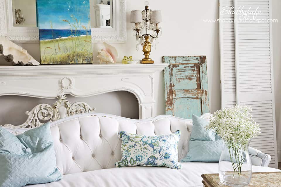 five minute styling tips - light blue and green accents in a white room with coastal artwork