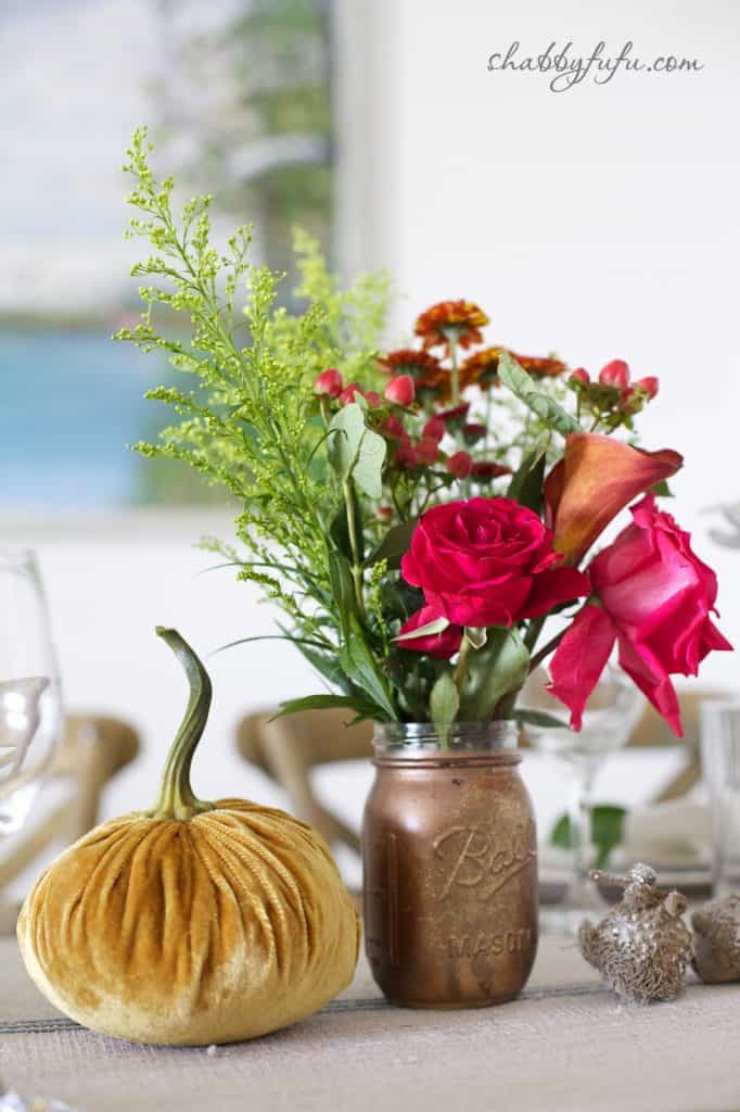 Thanksgiving Beach House decor - tablescape centerpieces with bright fall flowers and velvet pumpkins