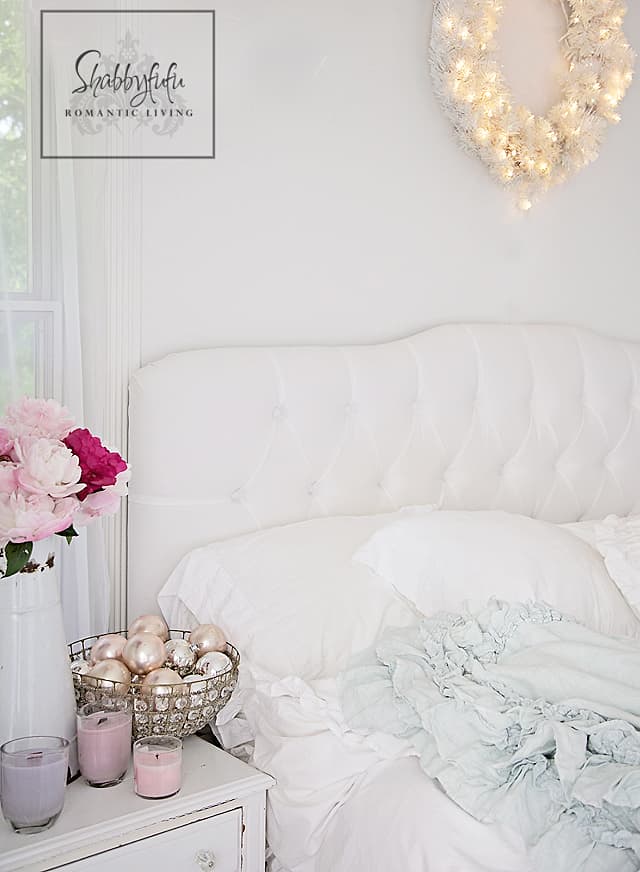 decorating with white - white bed linens make for a romantic setting accented with bright pink flowers and silver globes.