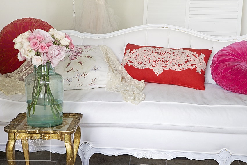We mix and match throw pillows by pairing bright, bold reds and pinks with soft florals and neutral colors. 