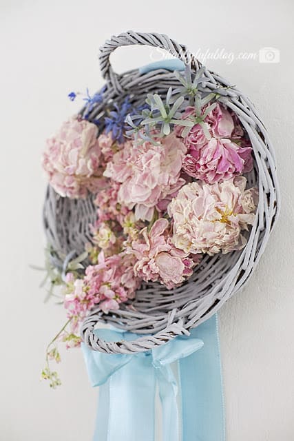 This floral peony wreath was made with some fresh peony flowers, an old white-washed wicker basket, and some hot glue! Such a simple project.