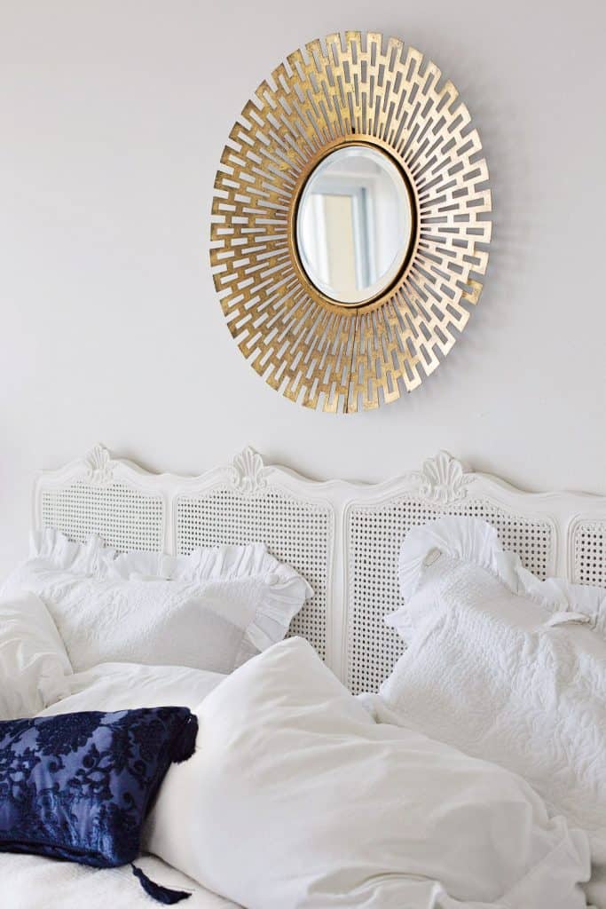 modern gold mirror over bed