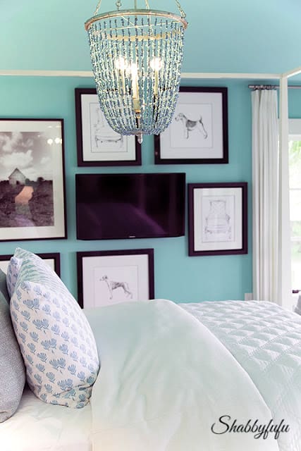More coastal colors in the master bedroom. This teal paint looks beautiful against white and black artwork.