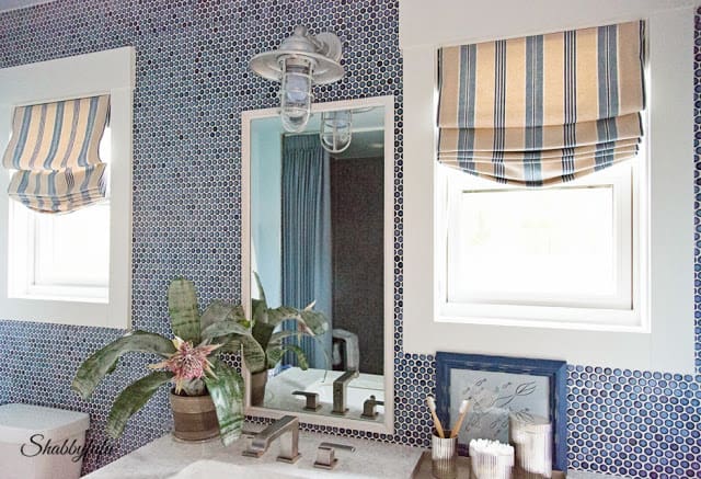Bathroom in the HGTV Dream Home 2016 - a blue penny tile wall design looks flawless against the bright sunshine.