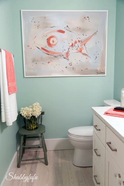 Bathroom in the HGTV Dream Home 2016 - these coastal colors continue with this mint green wall color, accented with touches of coral. 