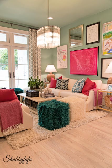 Family media room in the HGTV Dream Home 2016 - It has brightly colored mint-green walls and is accented with bright green and pink pillows, blankets, and automens. 