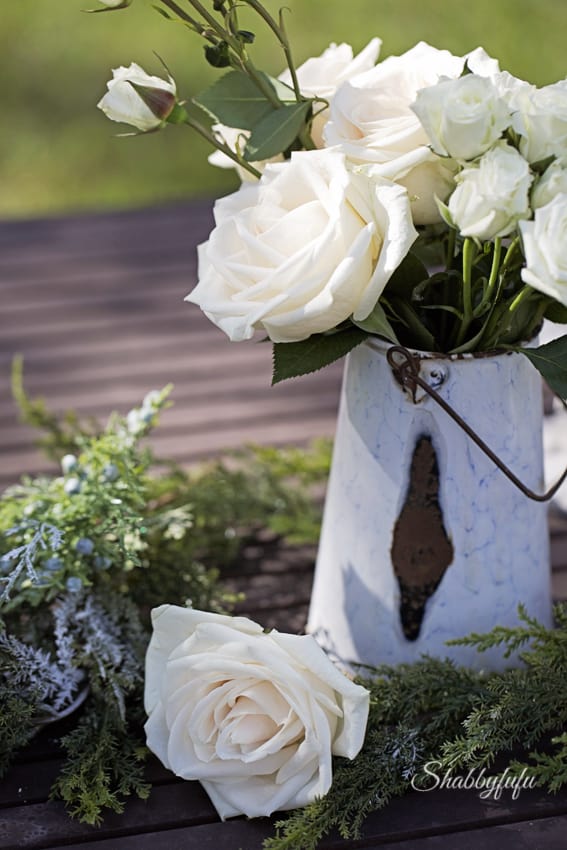 white rose garland on an outdoor table
