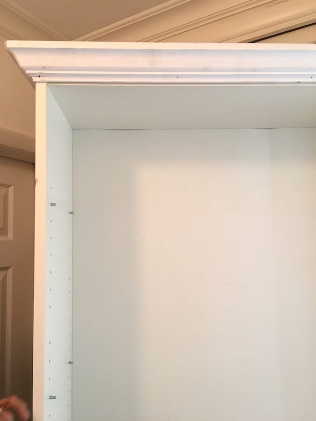 We added crown molding to the top of this Ikea Billy Bookcase to give it an elegant and fresh look. Add a coat of white paint and that's a wrap for this Ikea Billy Bookcase Hack.