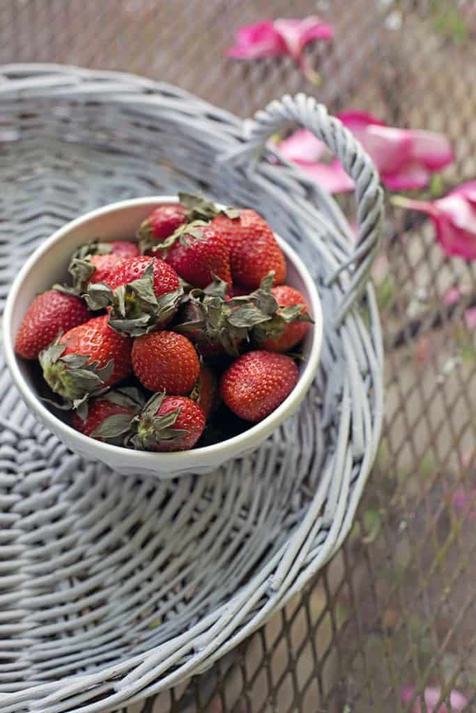 bowl of strawberries on a wicker tray