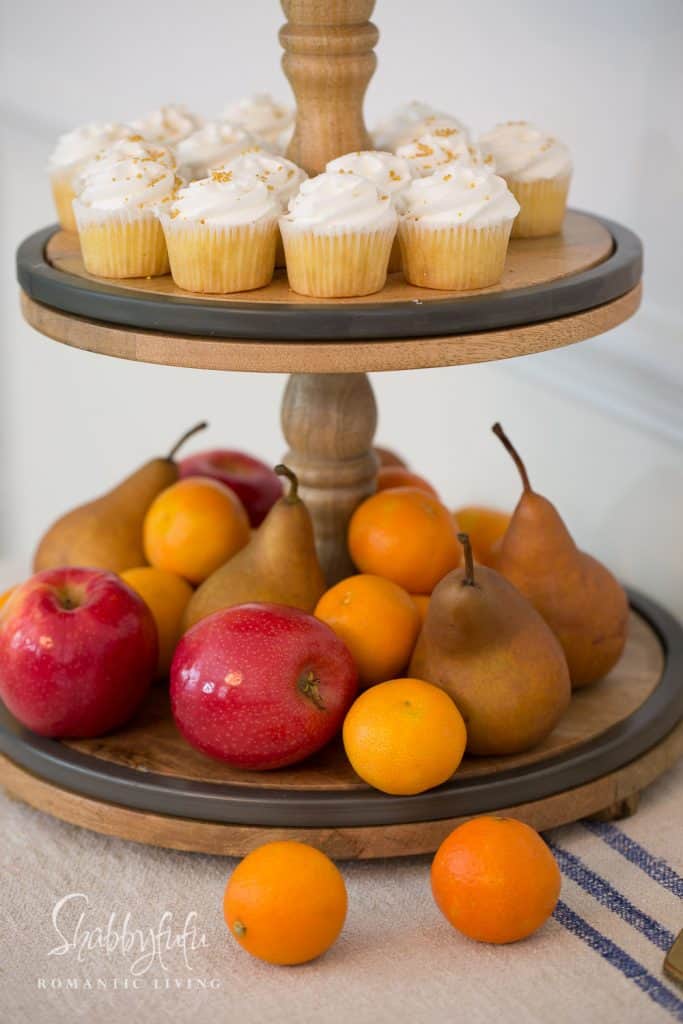 buffet stand with fruit and cupcakes