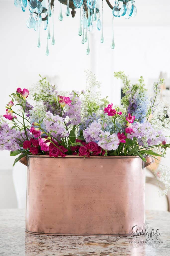 copper pot filled with flowers