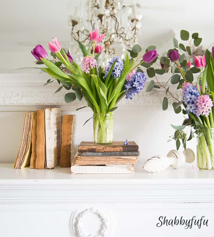 books and flowers on a french mantel