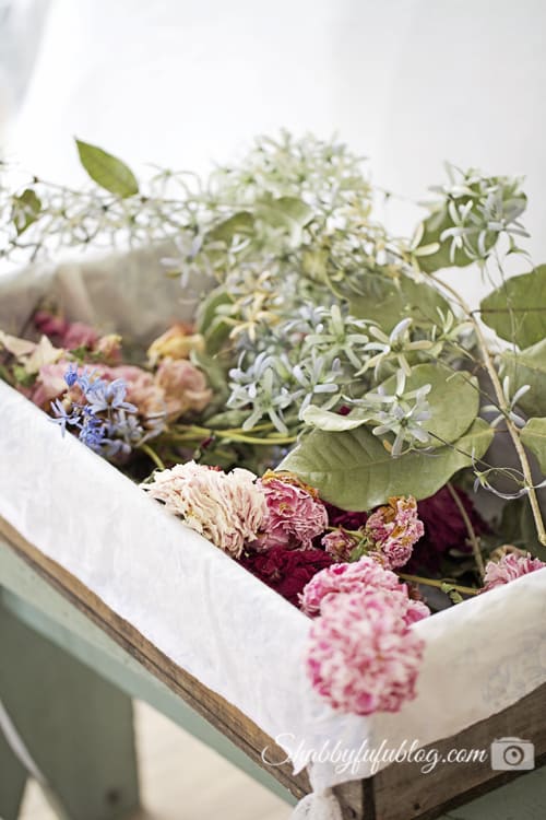 drying flowers in a blue berry crate