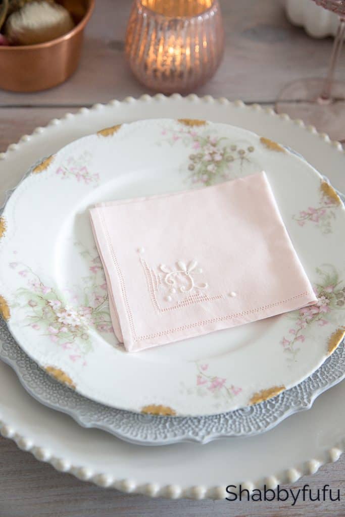 vintage plate stack with a pink napkin