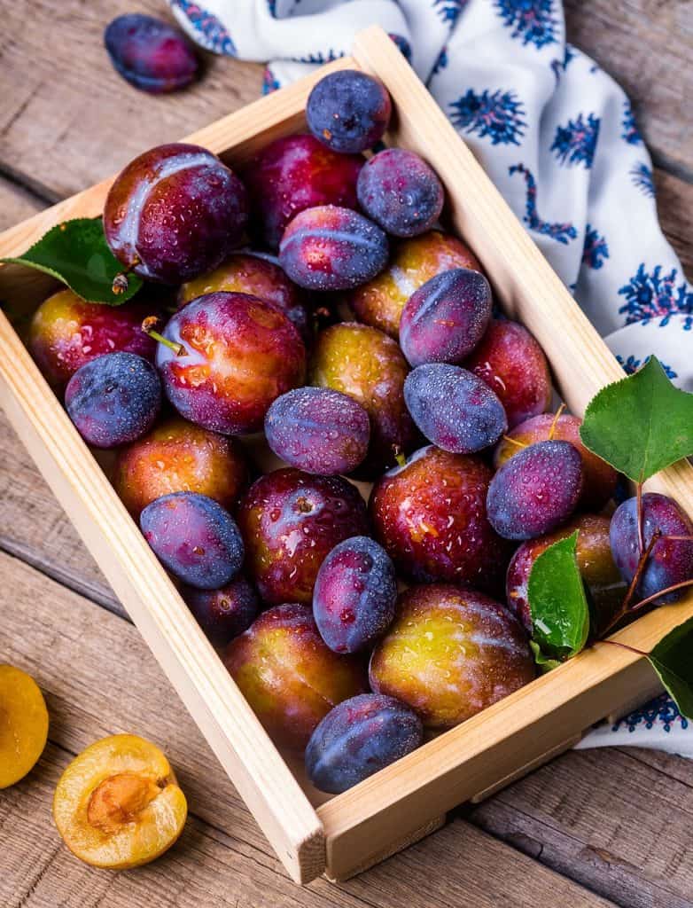 wood crate with plums