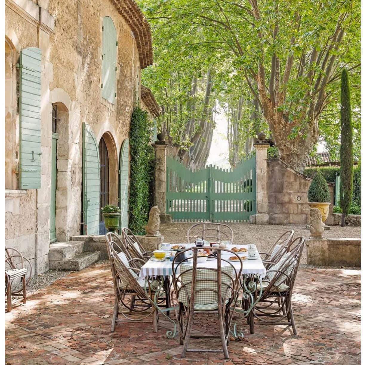 french countryside outdoor patio with long table and bistro chairs