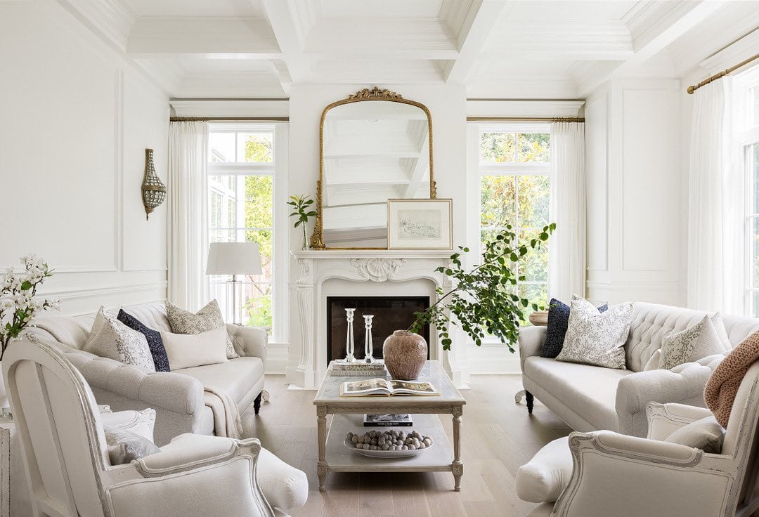 French country inspired living room with white sofa and armchairs