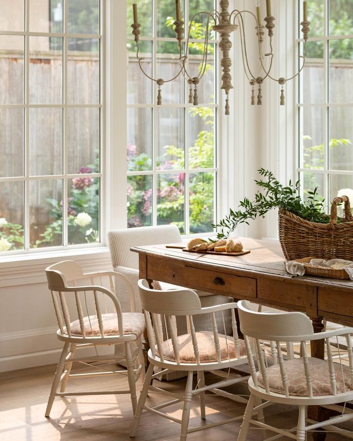 French country inspired dining room with dining table and white chairs