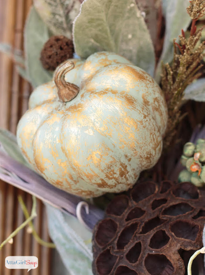 dusty green pumpkin streaked with gold highlights in a grapevine wreath