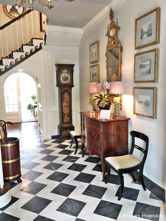 foyer with black and white tile floor and antique furniture