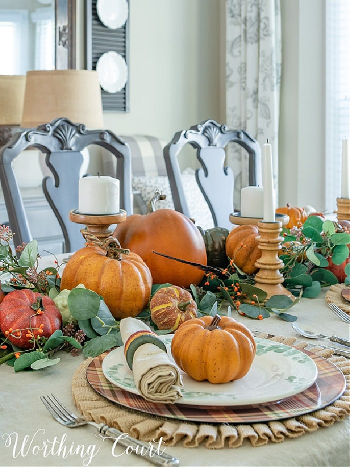 Thanksgiving centerpiece with pumpkins and greenery