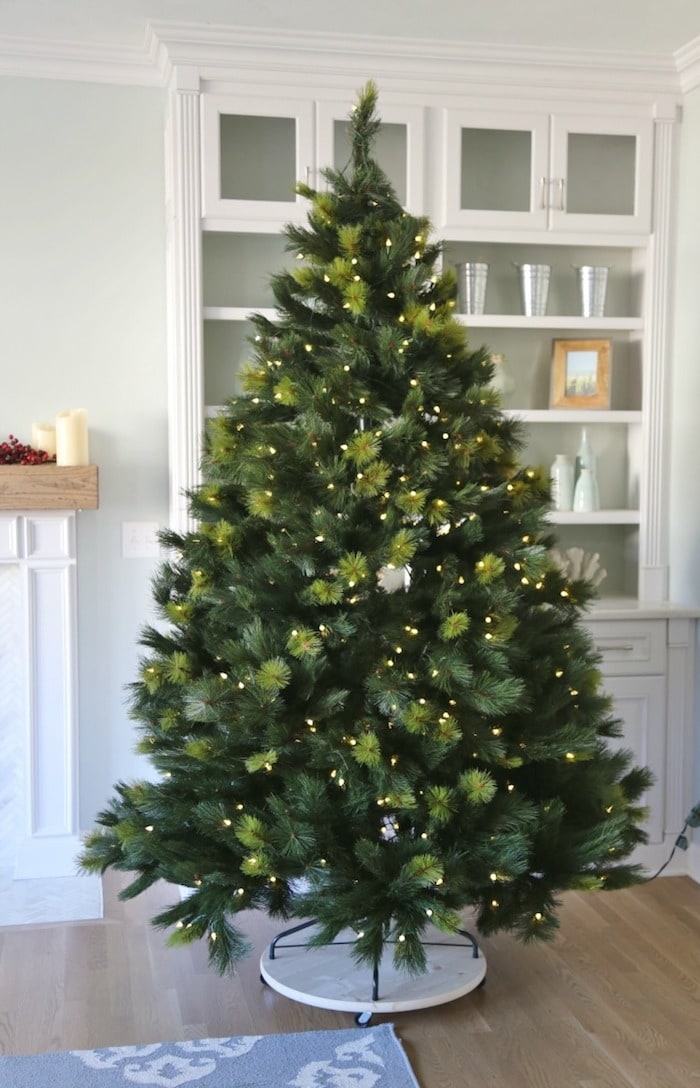 Green Christmas tree with lights on but no decorations on the tree
