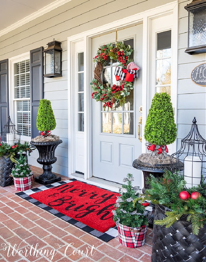 front porch with red, green and black Christmas decorations