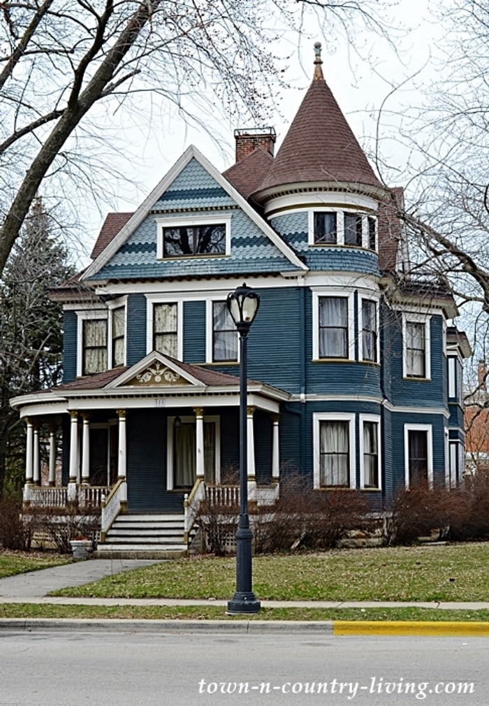 exterior of a Victorian style house painted shades of blue with white trim