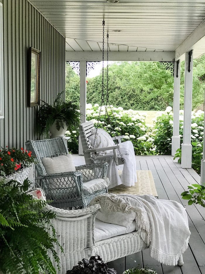 covered porch with white wicker furniture