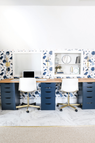 after modern feminine home office DIY makeover with blue and pink wallpaper and large dual desk