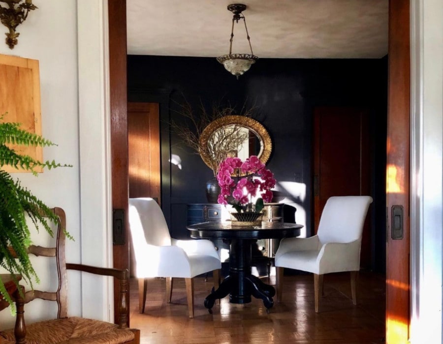 elegant dining room with a dark color scheme after decor makeover
