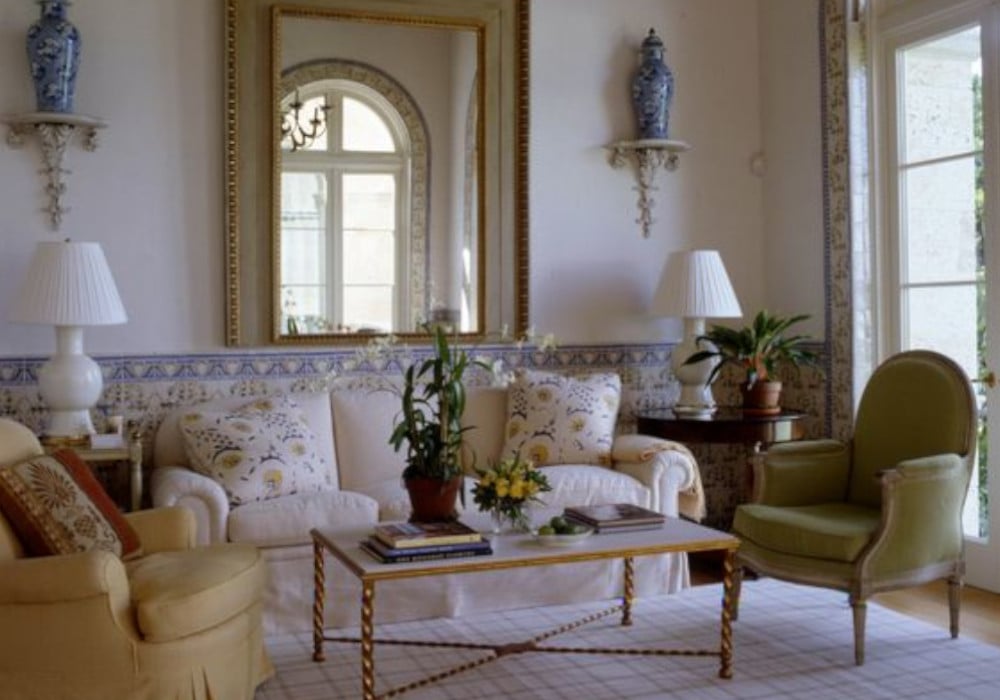 traditional living room with two armchairs, sofa and mirror on the wall