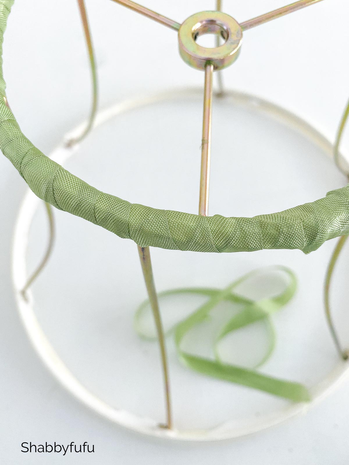 wrapping ribbon around the diy floral chandelier frame