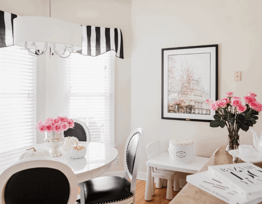 Bistro inspired kitchen nook featuring black and white striped rugs and curtains