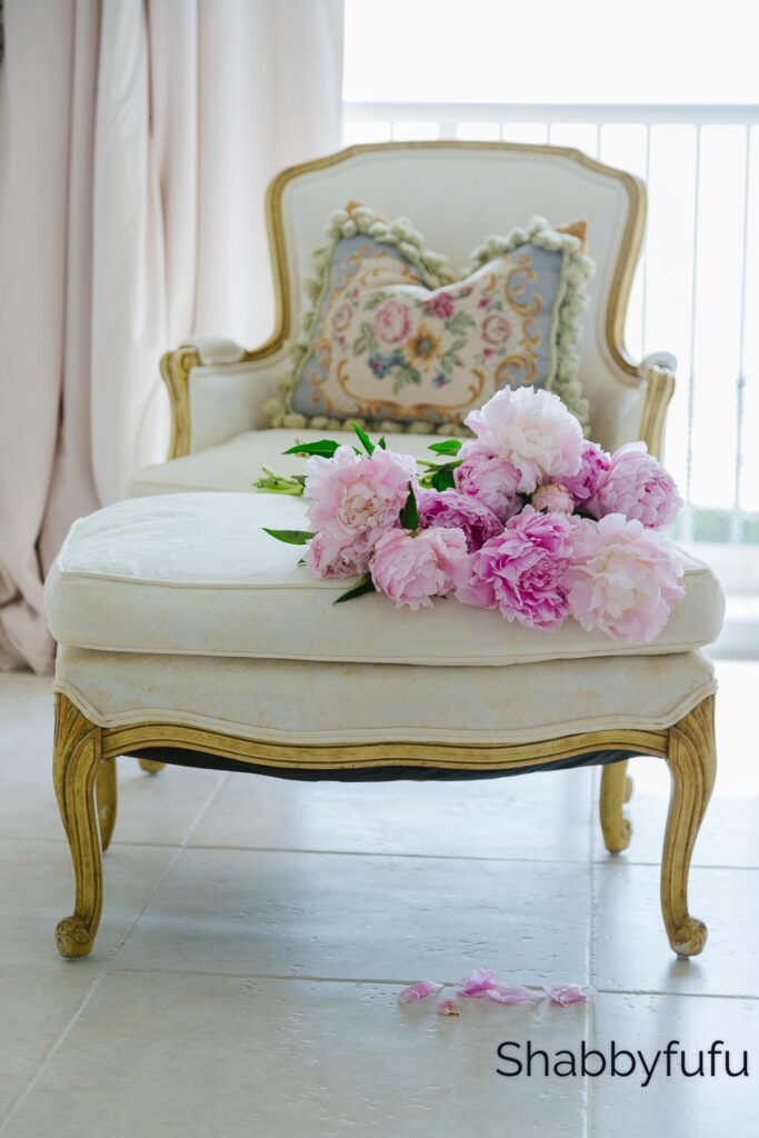 french style armchair with a floral arrangement on top