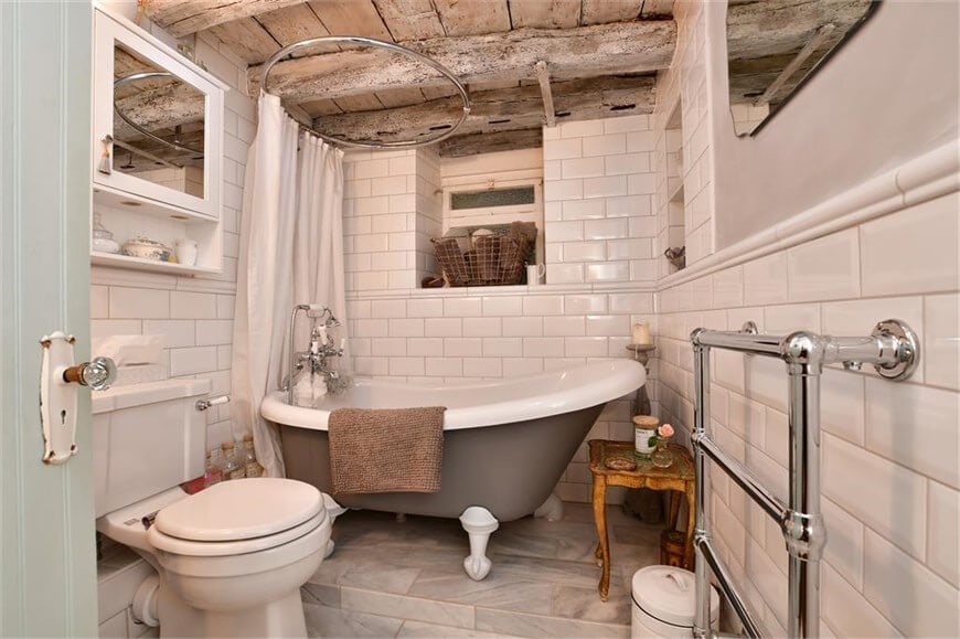 English cottage home bathroom featuring cast iron pedestal bathtub