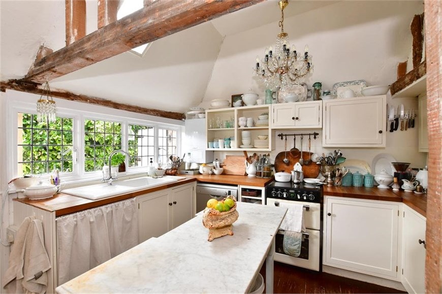 English cottage home kitchen with exposed wood beams and white walls