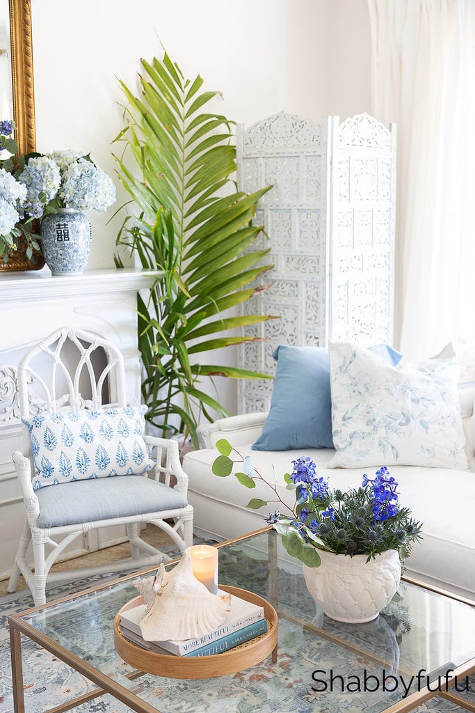 living room furniture featuring a sofa and chair in white and blue shades