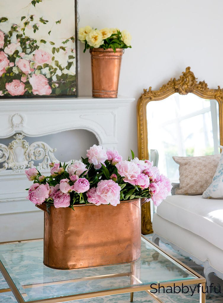 copper flower vase with pink peonies against a classy neutral living room