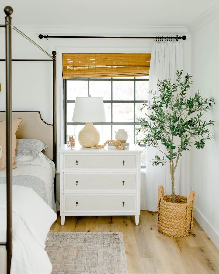 Bedroom featuring windows with bamboo shades - window treatments idea