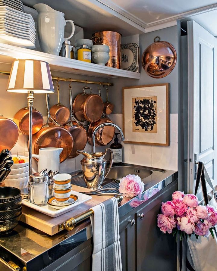 artistic boho kitchen style featuring copper pots, framed art and lamps. Ideas for redecorating your home for free