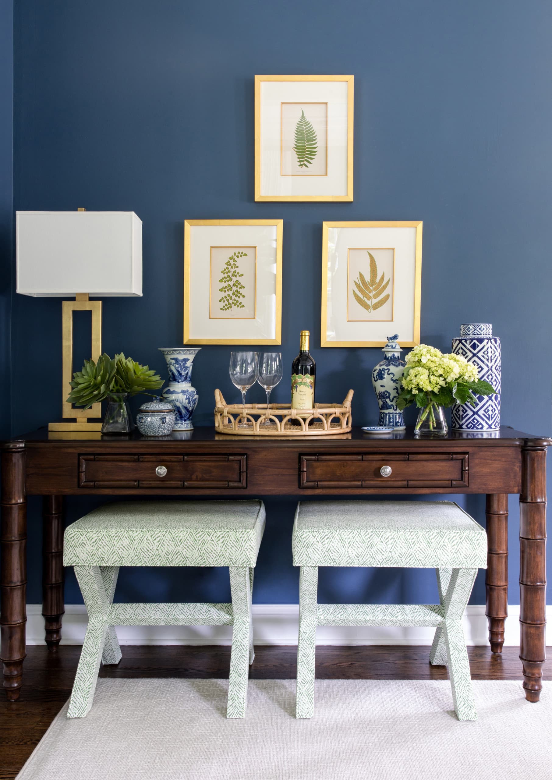 colorful elegance, entryway idea home tour featuring a dark blue wall and a condole table against it