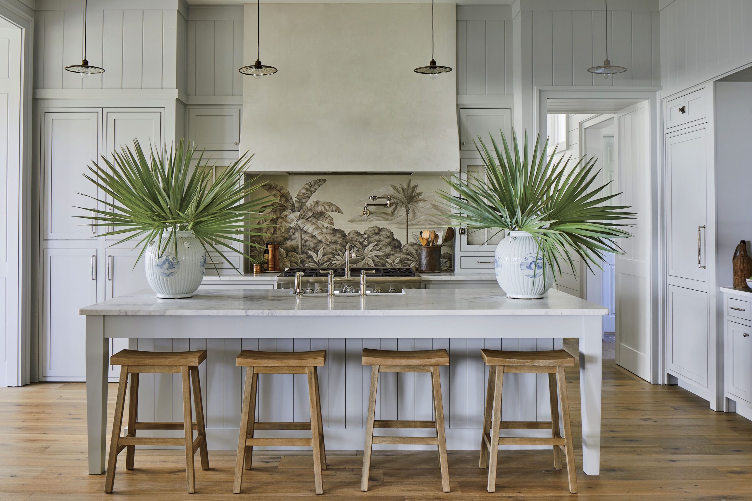 beach style kitchen island featuring palm leaves inside vases