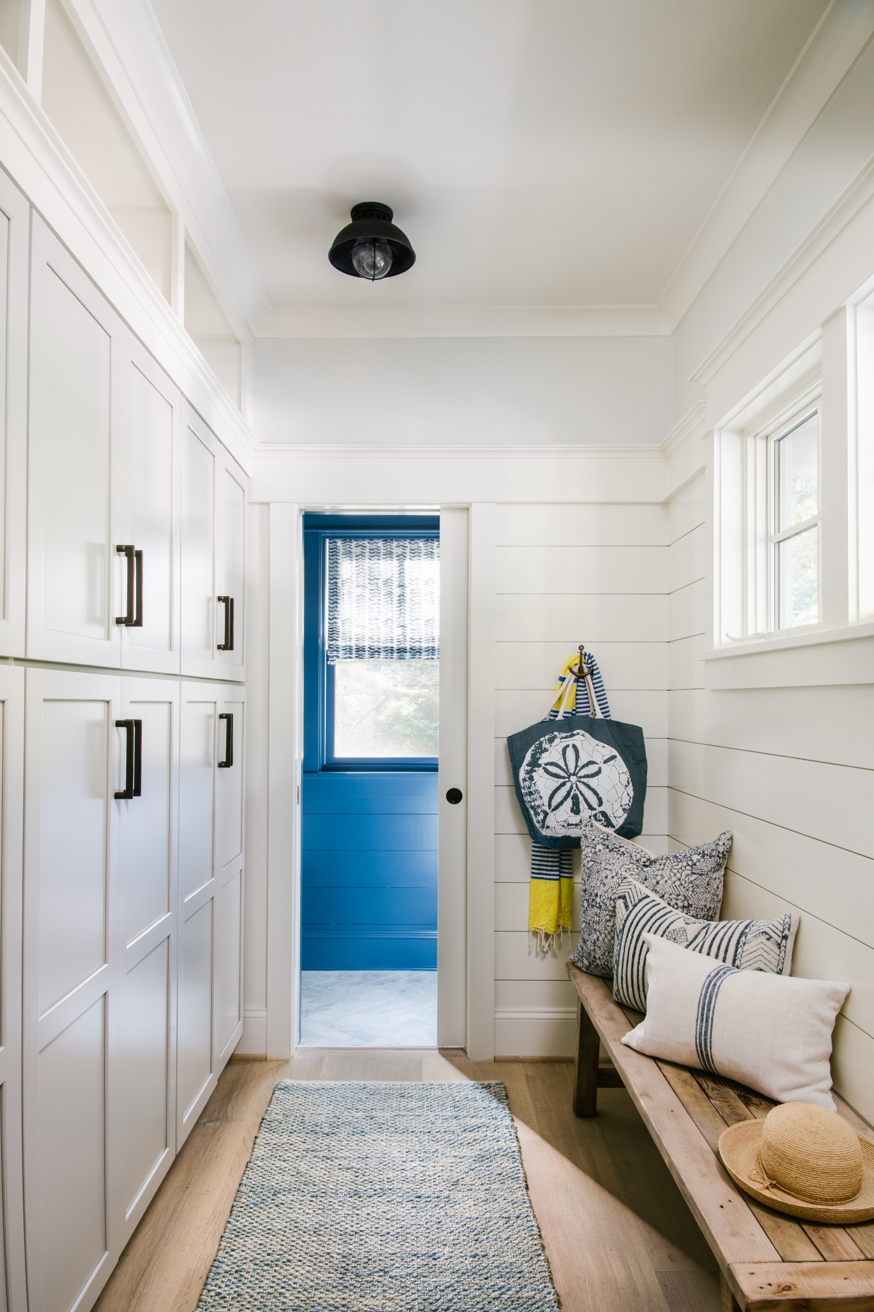 example of coastal cottage entryway featuring white and blue wall