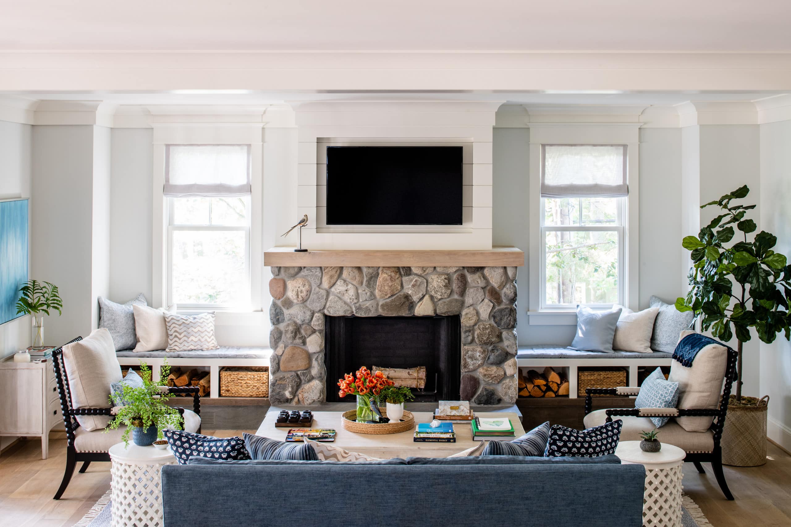 Ideas of a coastal cottage inspired living room featuring a stone wall fireplace