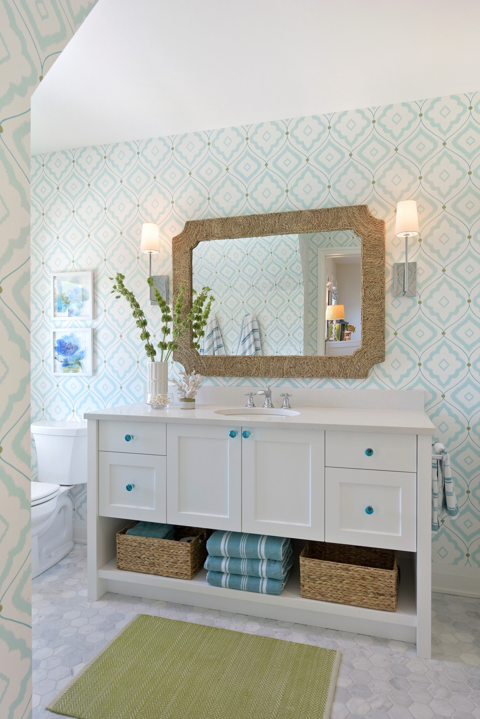 coastal cottage bathroom with blue accents and floral wallpaper
