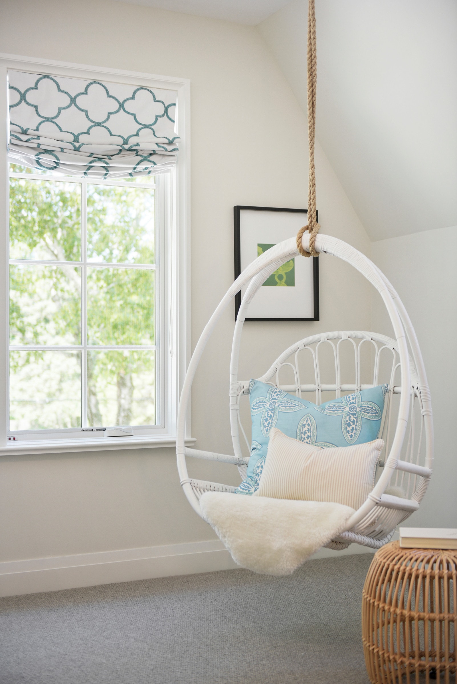 kids bedroom in coastal cottage home featuring a white bamboo hammock chair