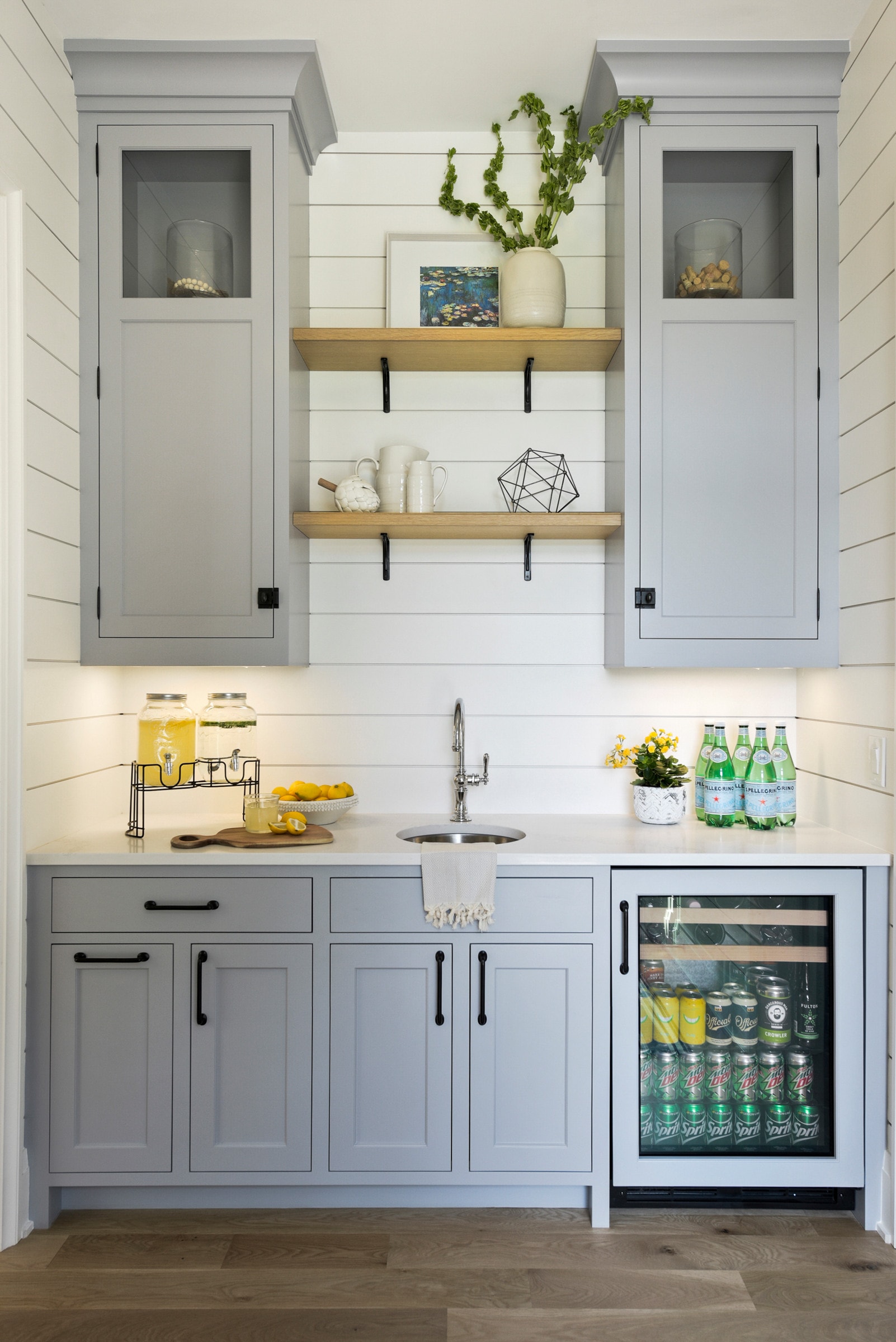 coastal cottage home bar featuring built in furniture cabinets in light grey 