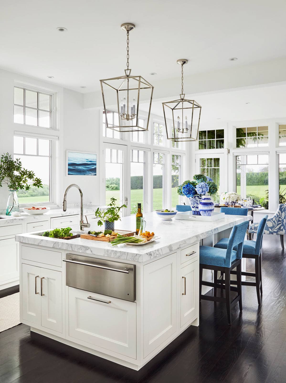 coastal home kitchen featuring marble island and blue accent decor