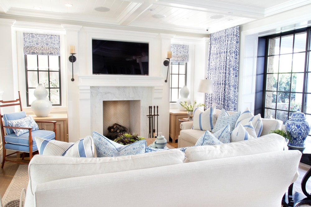 family room in a cozy coastal home featuring white and blue pillows 